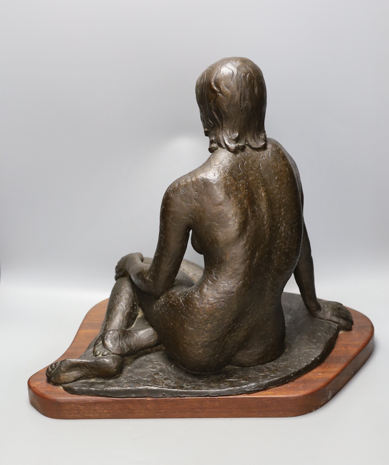 Audrey Shaw. A bronzed resin figure of a seated girl, 43cm tall